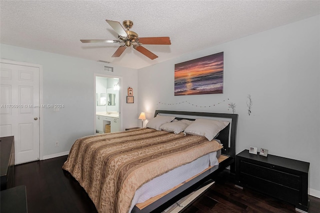 bedroom with a textured ceiling, connected bathroom, dark hardwood / wood-style floors, and ceiling fan