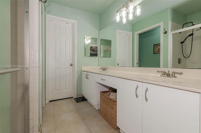 bathroom with tile patterned floors, vanity, and a shower with shower door