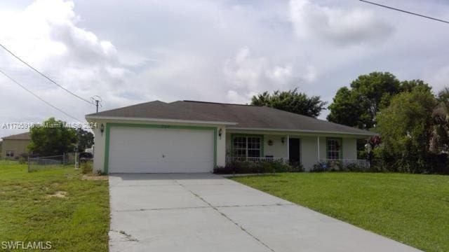 single story home featuring a garage and a front lawn