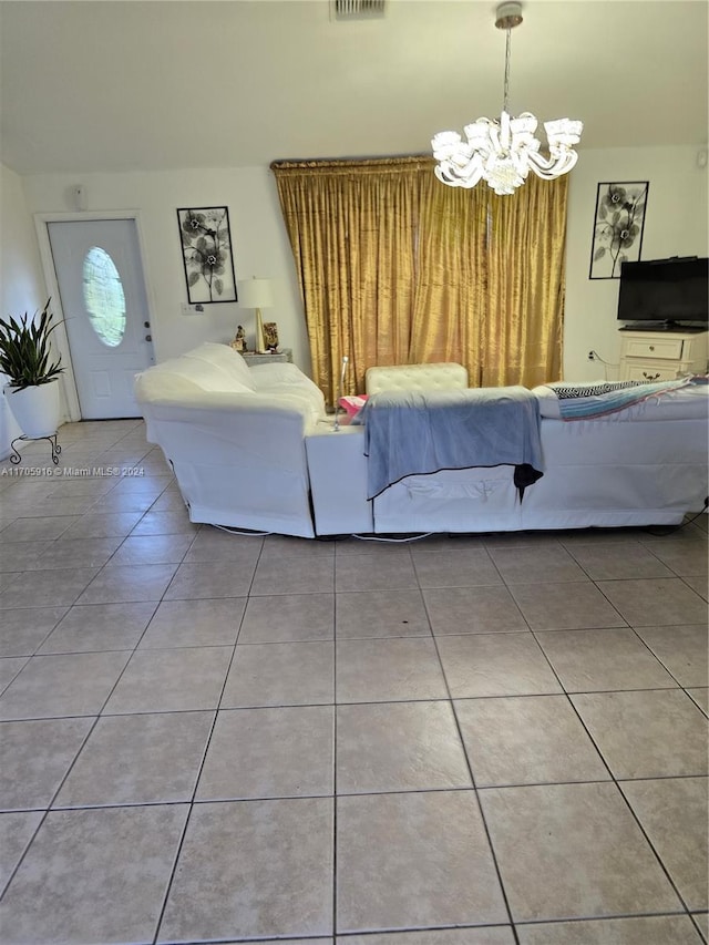 tiled living room featuring a chandelier