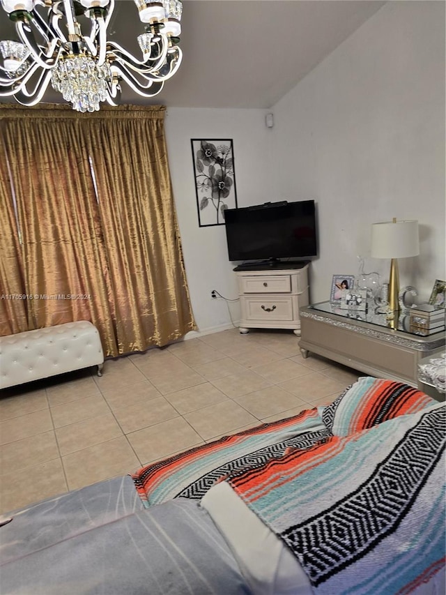 bedroom with light tile patterned floors, vaulted ceiling, and a notable chandelier