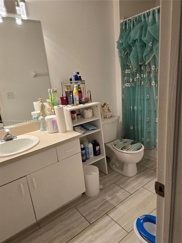 bathroom featuring vanity, hardwood / wood-style flooring, and toilet