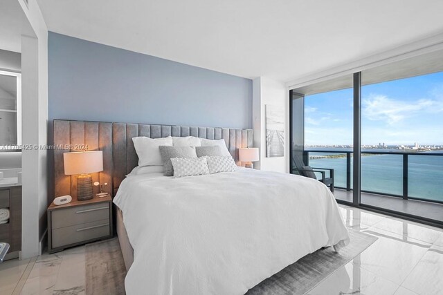 460 NE 28th St Unit 3205, Miami, FL 33137 - bedroom featuring expansive windows, access to exterior, light marble finish floors, and a water view