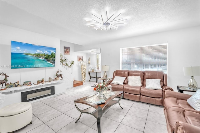 living room featuring light tile patterned floors, a textured ceiling, and a chandelier