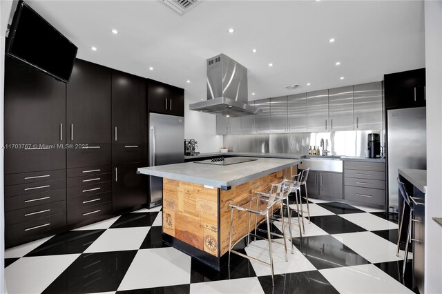 1800 NE 114th St Unit Ph05, Miami, FL 33181 - kitchen featuring a kitchen island, island exhaust hood, stainless steel refrigerator, and black electric cooktop