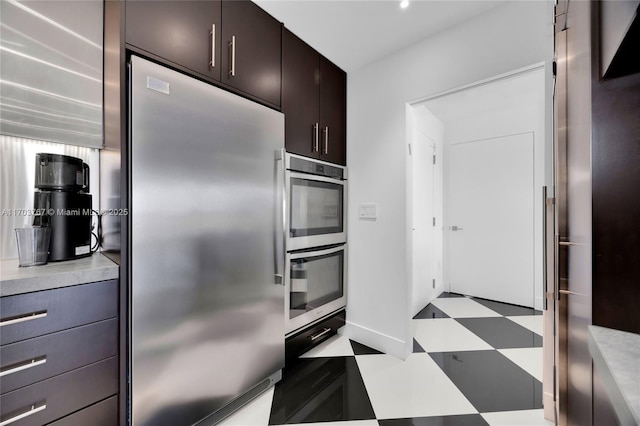 1800 NE 114th St Unit Ph05, Miami, FL 33181 - kitchen with appliances with stainless steel finishes and dark brown cabinets