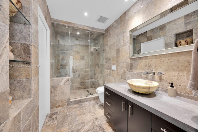 1800 NE 114th St Unit Ph05, Miami, FL 33181 - bathroom featuring a shower with shower door, toilet, tile walls, vanity, and backsplash