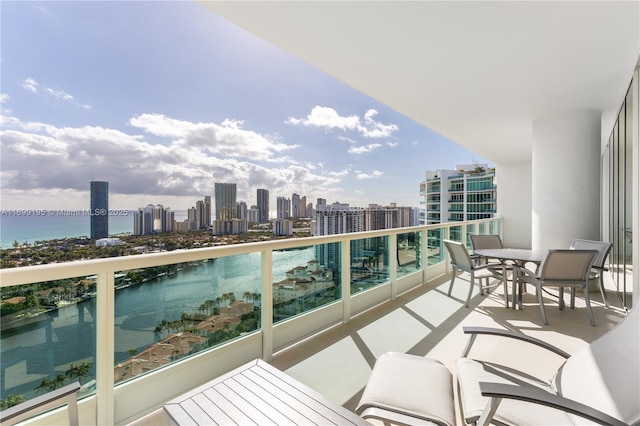 balcony featuring a view of city and a water view