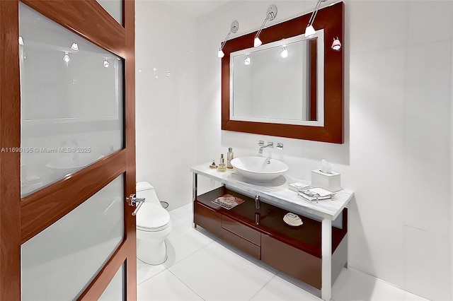 bathroom with vanity, toilet, and tile patterned flooring