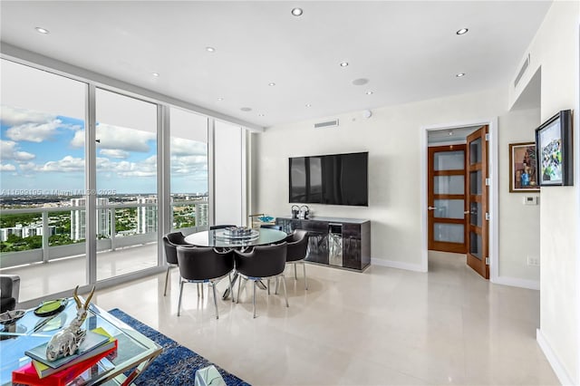 dining room featuring recessed lighting, visible vents, baseboards, and expansive windows