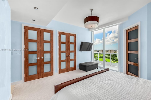 carpeted bedroom with recessed lighting, french doors, and access to outside