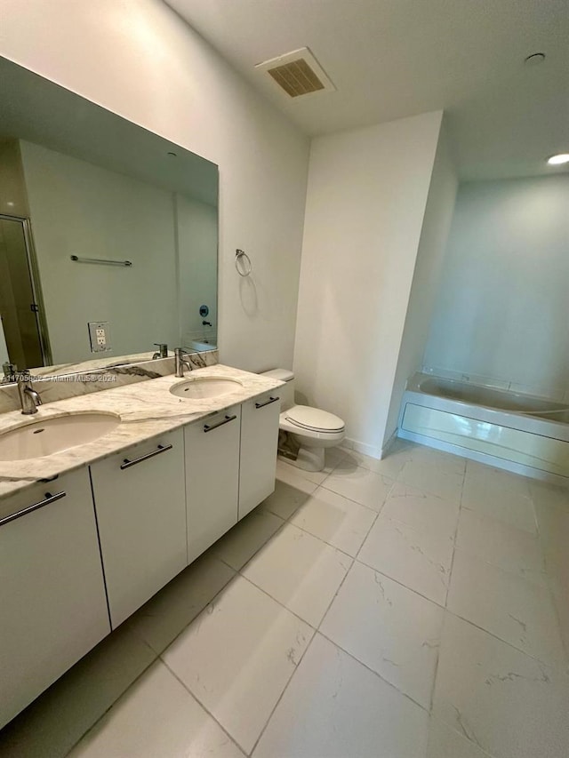 bathroom with vanity, a shower with shower door, and toilet