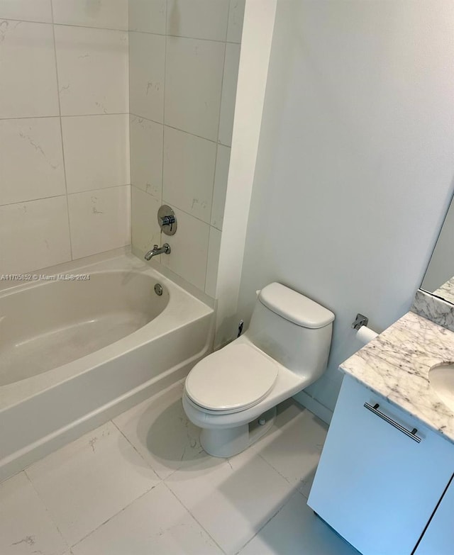 full bathroom featuring vanity, tile patterned floors, tiled shower / bath combo, and toilet