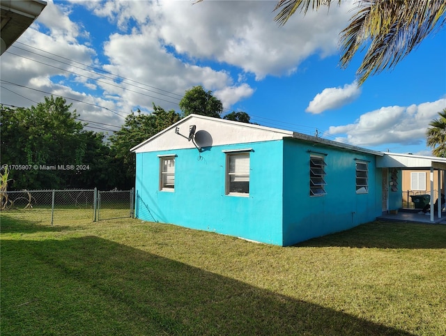 view of side of home featuring a yard