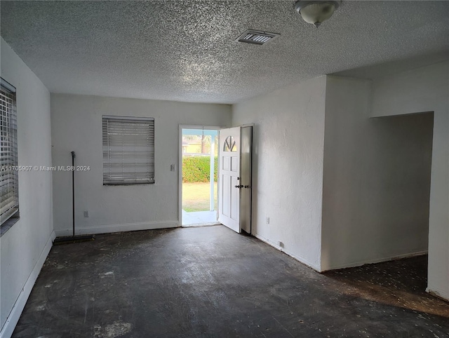 empty room with a textured ceiling