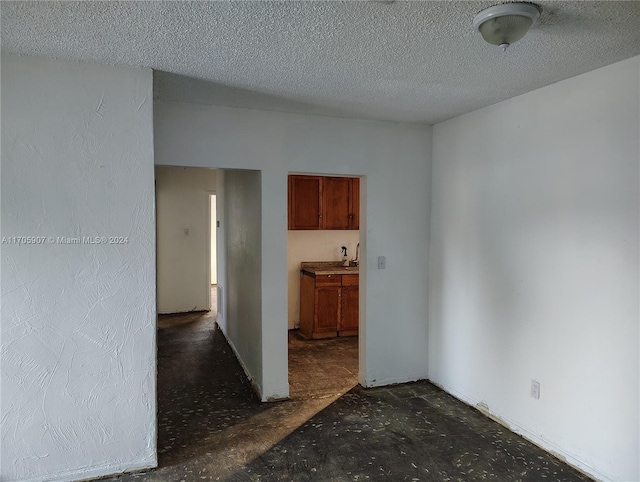 spare room with a textured ceiling