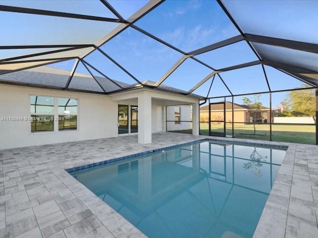 view of pool featuring glass enclosure and a patio