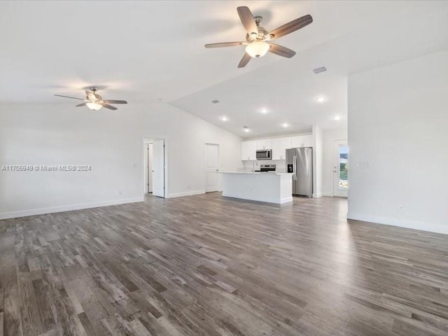 unfurnished living room featuring lofted ceiling, ceiling fan, and dark wood-type flooring