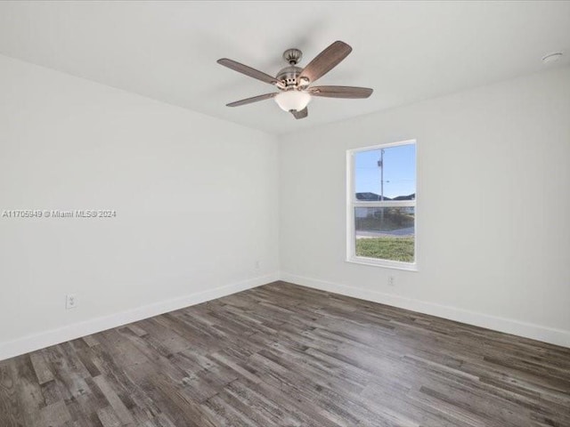 unfurnished room with ceiling fan and dark hardwood / wood-style flooring