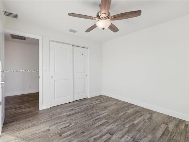 unfurnished bedroom featuring a closet, ceiling fan, and hardwood / wood-style flooring