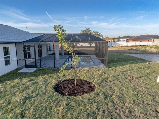 view of yard with a patio and a lanai