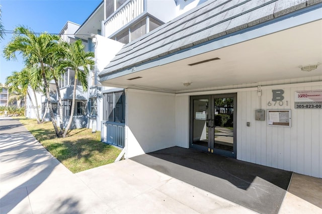 6701 NW 169th St Unit B207, Hialeah, FL 33015 - view of exterior entry with an attached carport