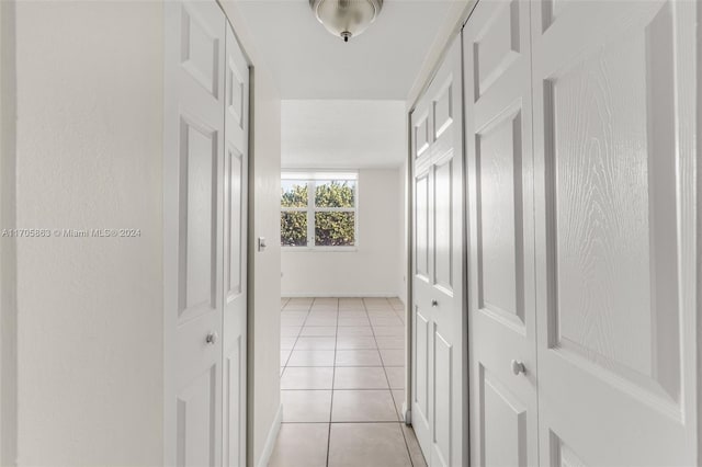 hallway with light tile patterned floors