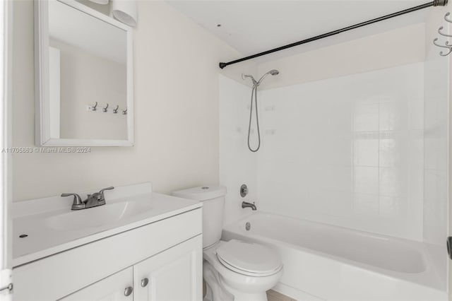 full bathroom featuring toilet, vanity, and tiled shower / bath