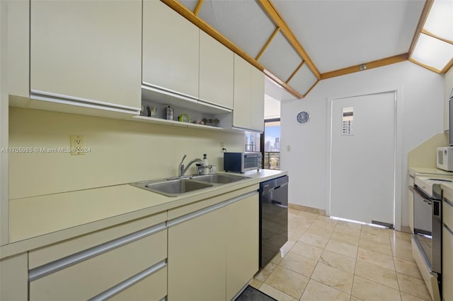 kitchen featuring light tile patterned flooring, stainless steel appliances, white cabinetry, and sink