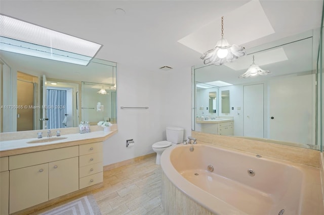 full bathroom featuring hardwood / wood-style floors, vanity, a skylight, toilet, and shower with separate bathtub