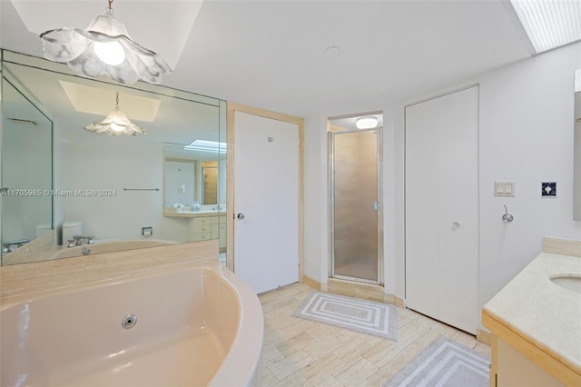 full bathroom featuring hardwood / wood-style floors, vanity, and independent shower and bath