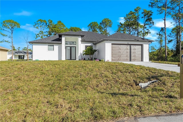 view of front of property featuring a front yard and a garage