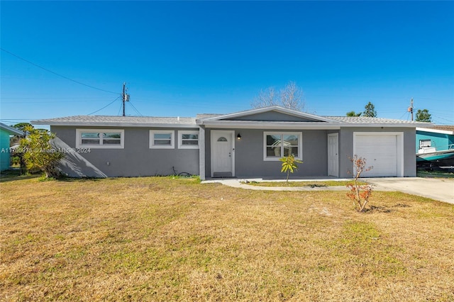 single story home with a front yard and a garage