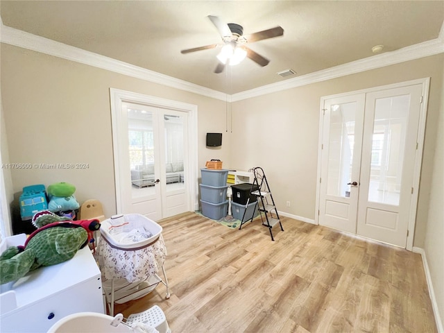 interior space with ceiling fan, light wood-type flooring, ornamental molding, and french doors