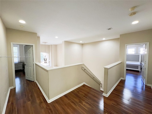 hallway with dark hardwood / wood-style flooring