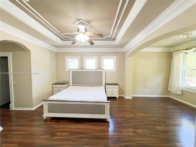 bedroom with dark hardwood / wood-style floors, a raised ceiling, ceiling fan, and ornamental molding