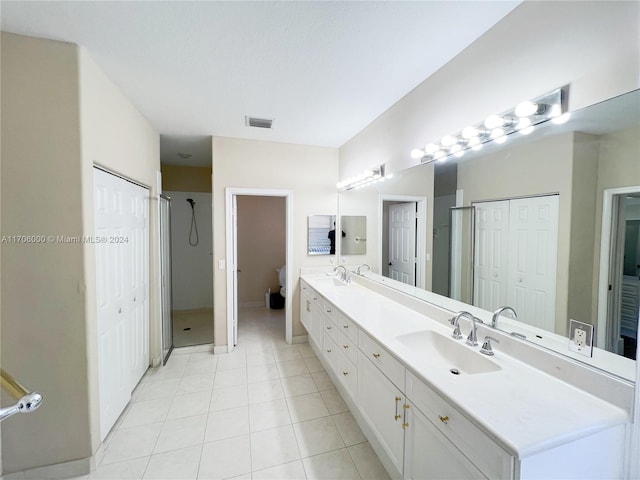 bathroom featuring tile patterned floors, vanity, and walk in shower