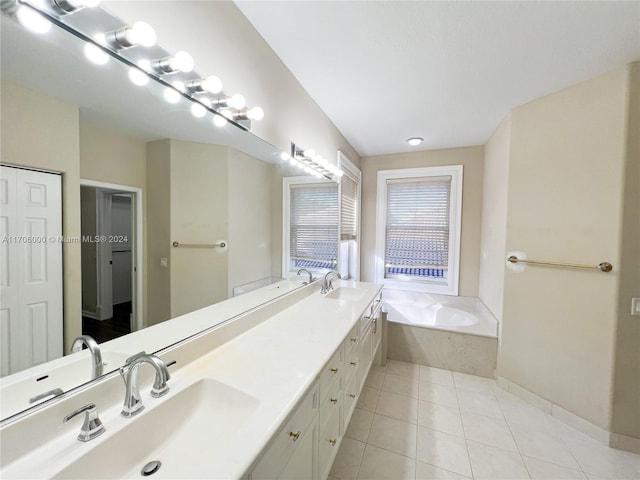 bathroom featuring tile patterned flooring, vanity, and a washtub