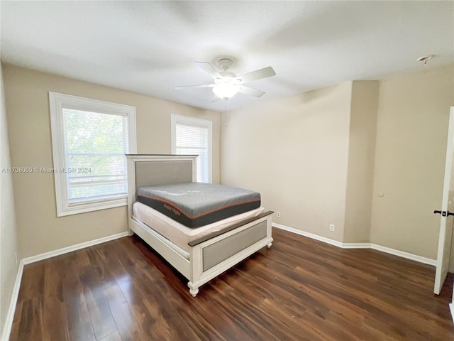 unfurnished bedroom featuring ceiling fan and dark wood-type flooring