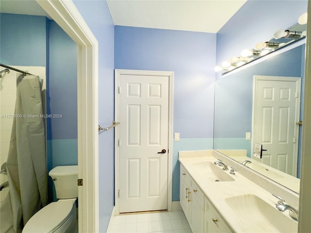 bathroom with tile patterned flooring, vanity, toilet, and walk in shower