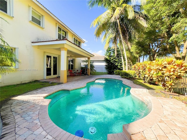 view of pool featuring a patio and ceiling fan