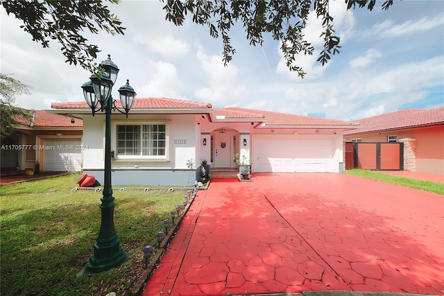 view of front of property featuring a garage and a front lawn