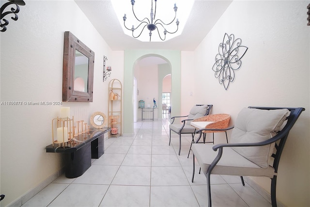 hall with a chandelier and light tile patterned floors