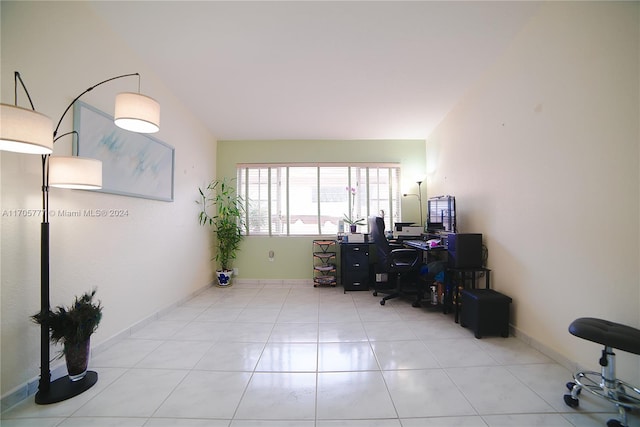 office space featuring light tile patterned floors and lofted ceiling