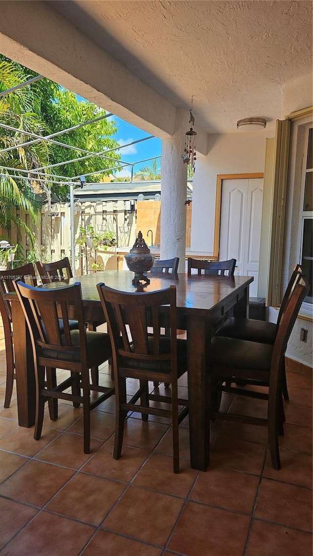 dining area with tile patterned floors and a textured ceiling