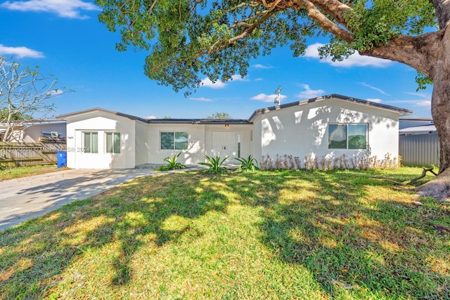 ranch-style home featuring a front yard