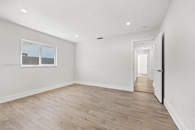 spare room featuring light hardwood / wood-style floors