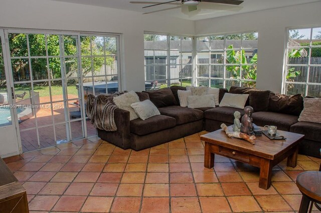 sunroom / solarium featuring ceiling fan