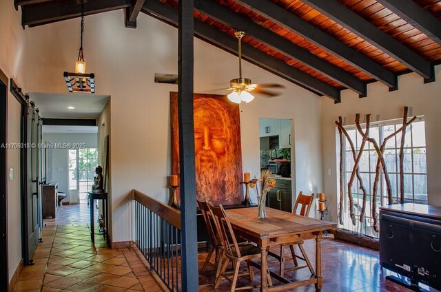 tiled dining room featuring high vaulted ceiling, ceiling fan, a barn door, wooden ceiling, and beam ceiling