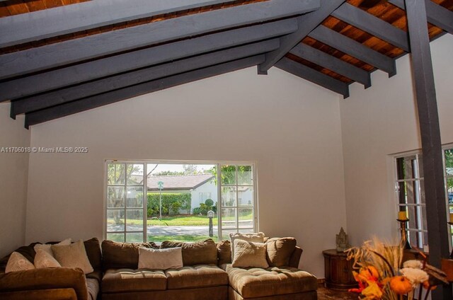 living room with vaulted ceiling with beams and wood ceiling